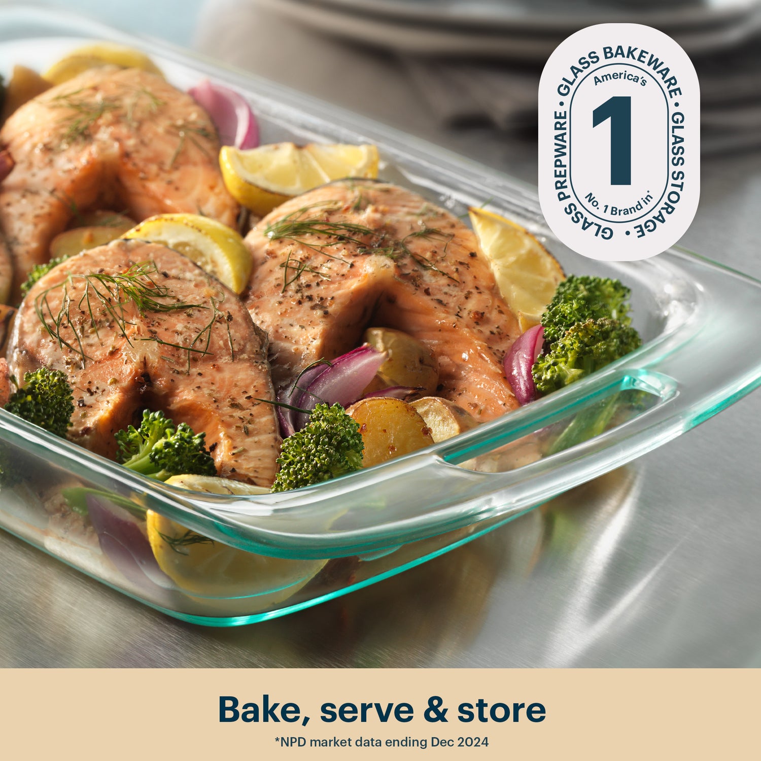 Glass baking dish with salmon and vegetables, featuring Pyrex logo.