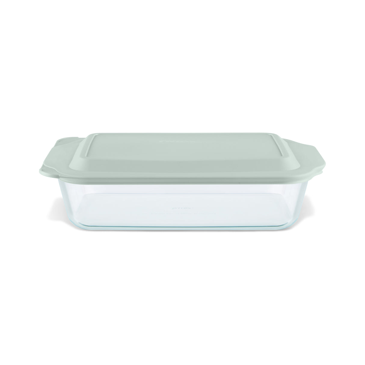 Glass baking dish with a green lid on a white background