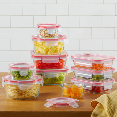 a set of pyrex glass containers with food on a wooden table