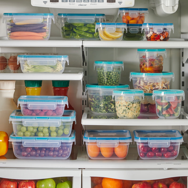Refrigerator filled with Snapware containers holding fresh fruits, vegetables, and prepared foods.