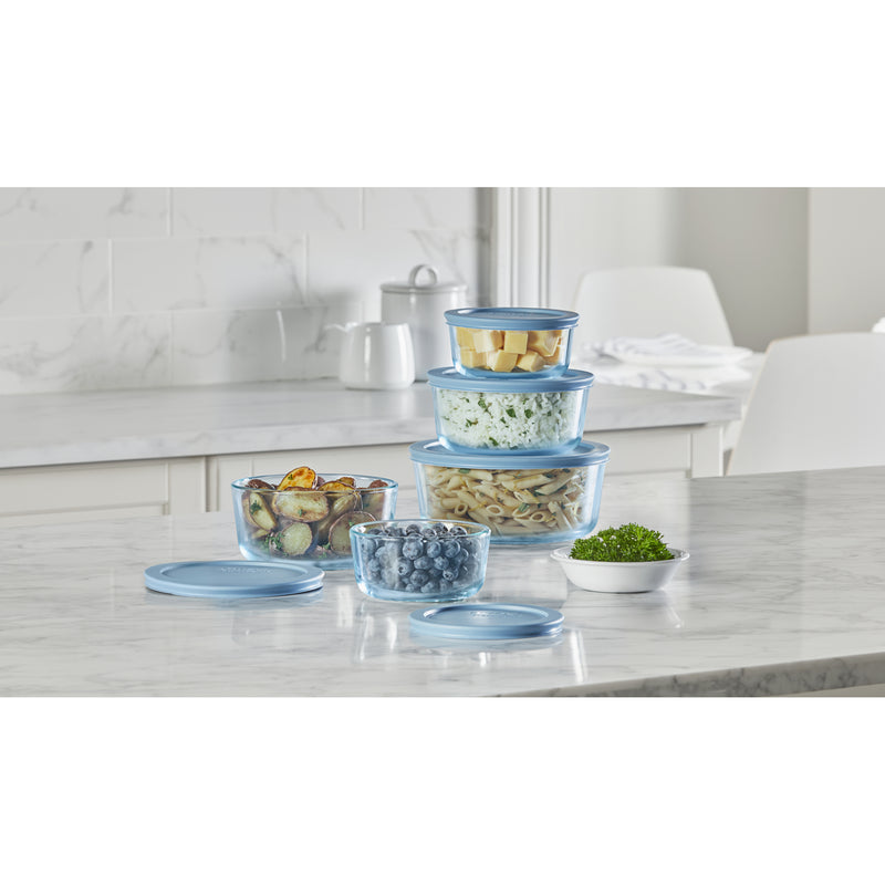 Stackable containers on a kitchen counter with food.