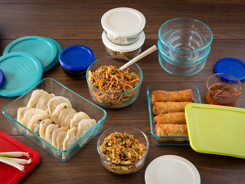 Assorted food items in containers on a wooden table