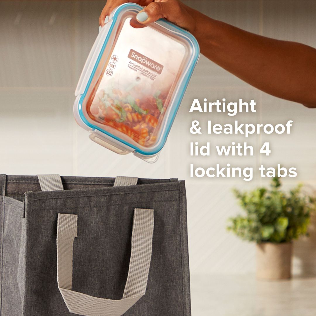 Hand holding a food container with an airtight lid, next to a tote bag and plant, with text highlighting features.