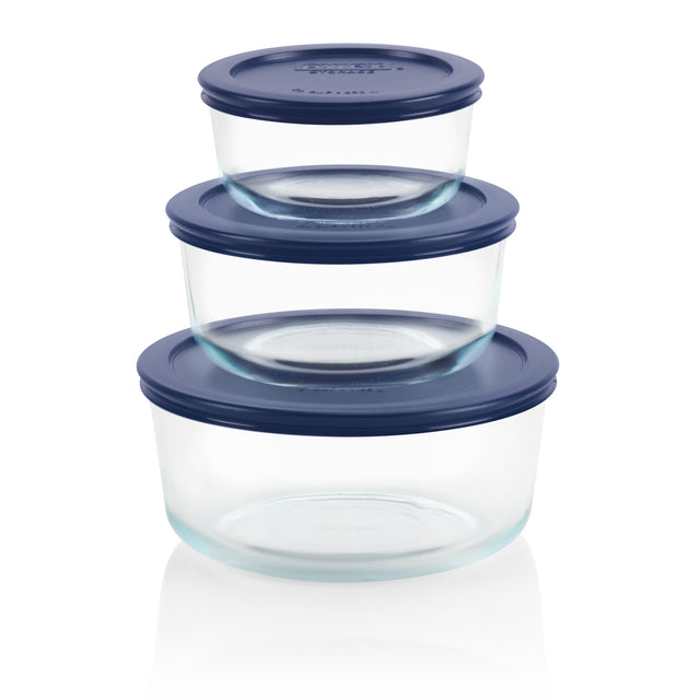 Set of three clear glass containers with blue lids on a white background