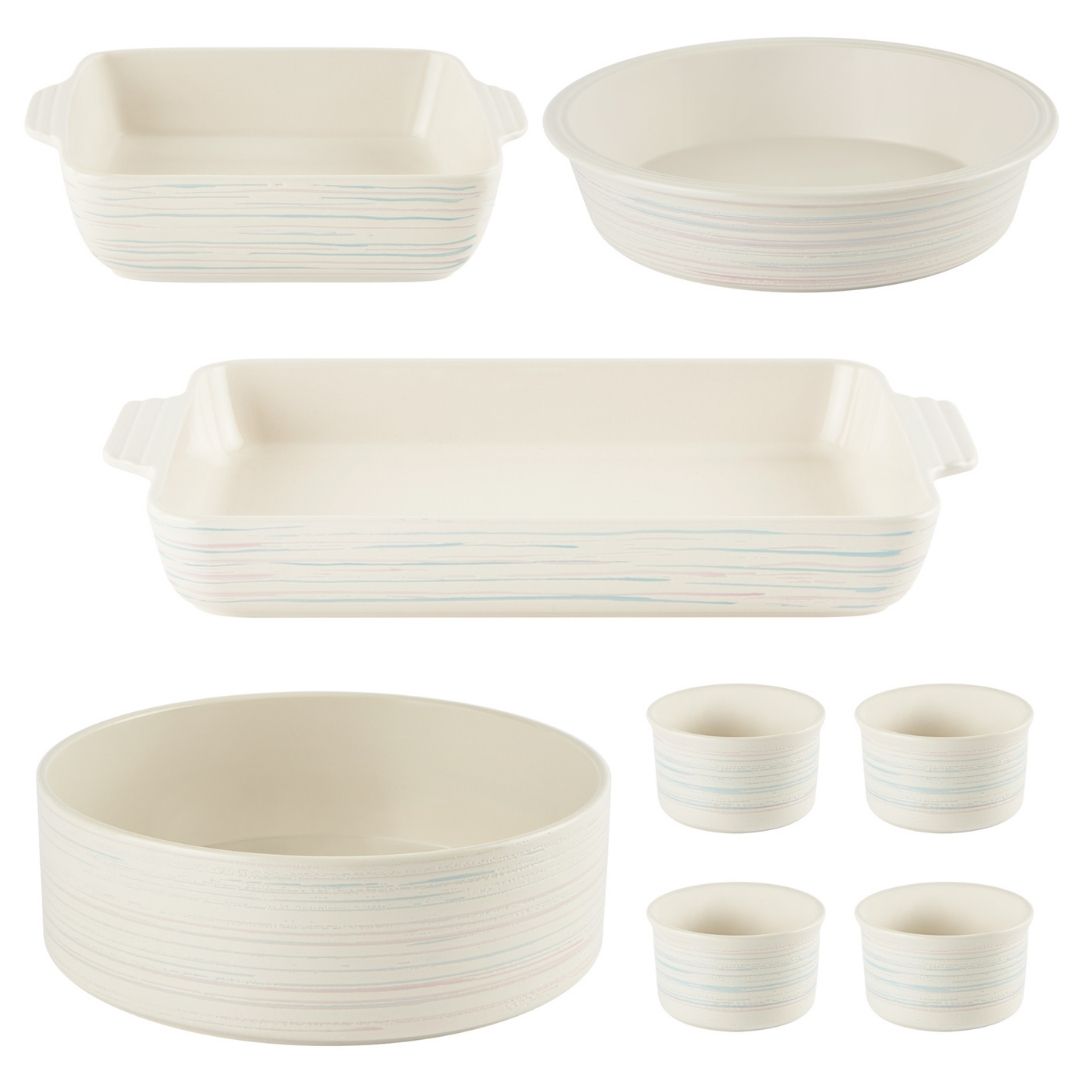 Set of ceramic cookware including bowls, casseroles, and cups on a white background