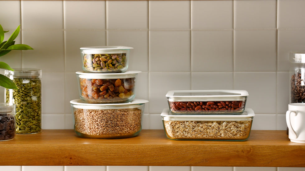 Set of food storage containers with lids on a kitchen counter