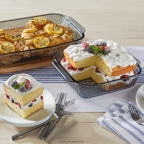 Glass bakeware with lemon chicken and layered berry cake served on plates.