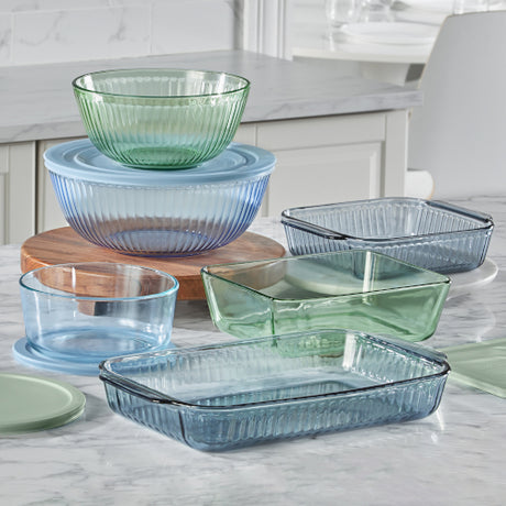 Colorful glass bakeware and bowls on kitchen counter.