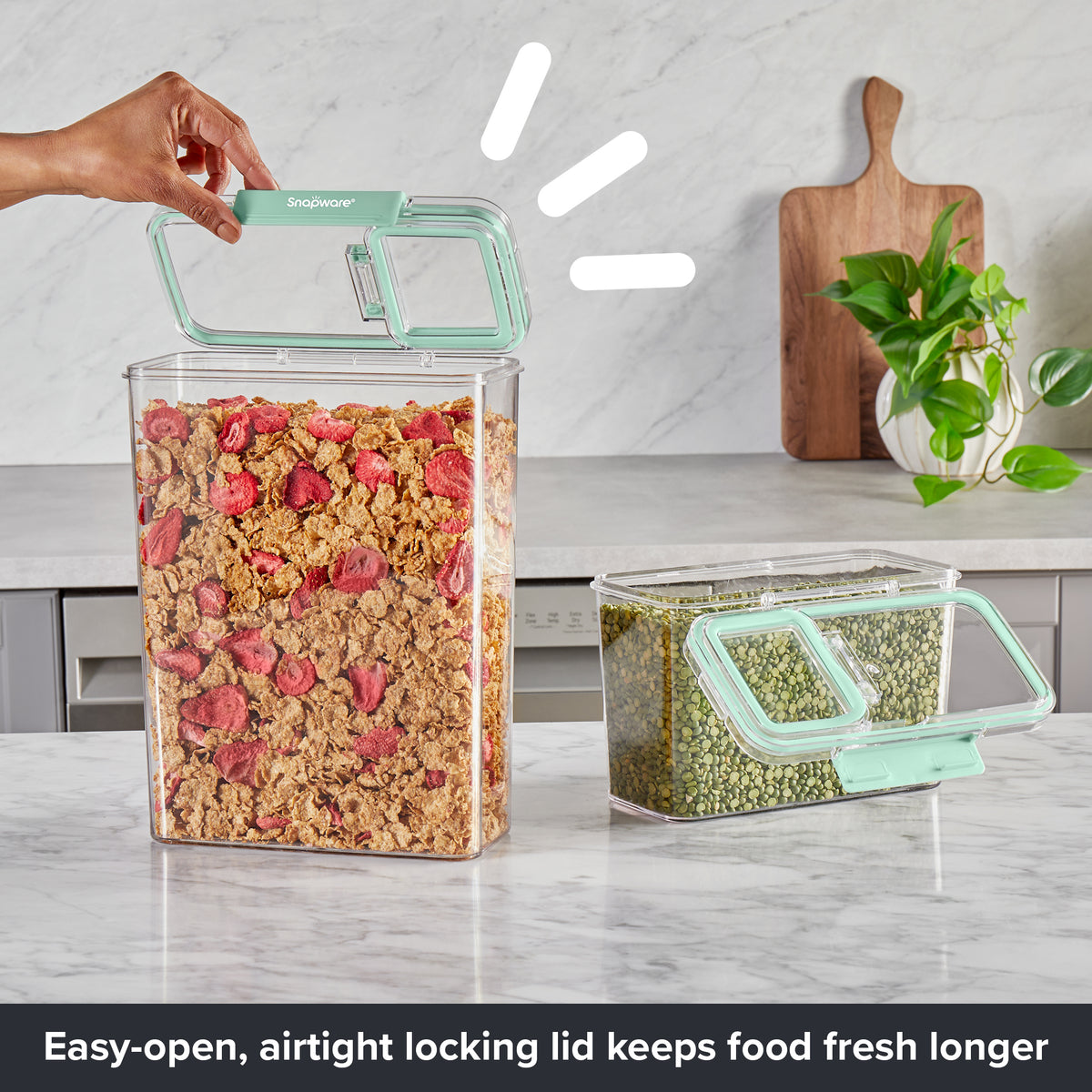 Close-up of Snapware® plastic storage containers featuring flip-open airtight lids, filled with cereal and split peas on a kitchen countertop.