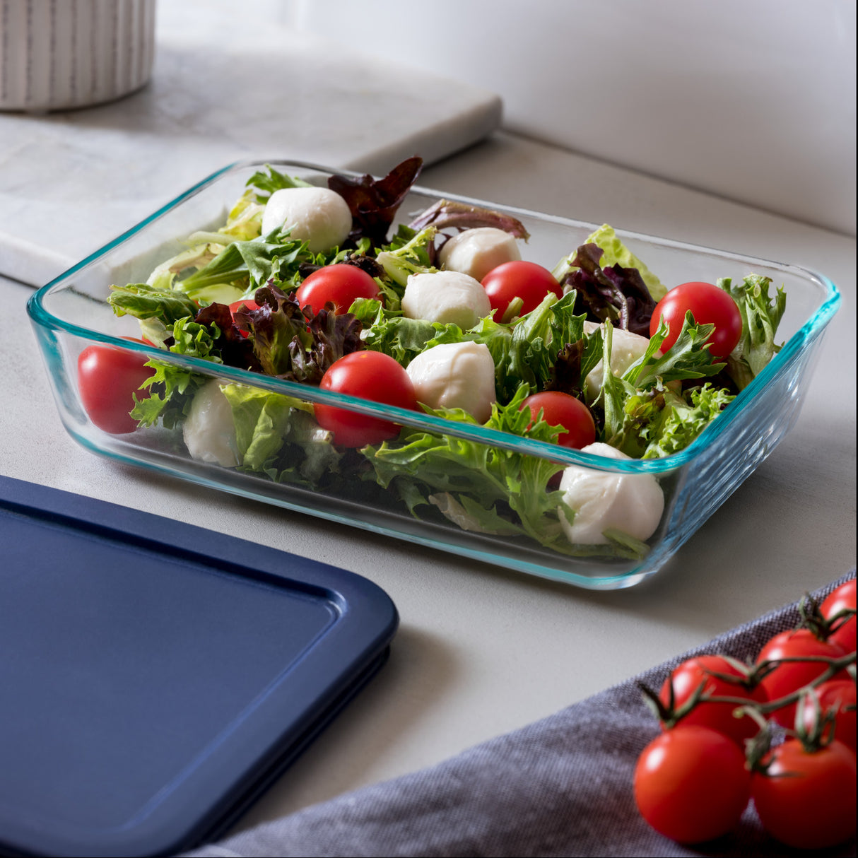 Glass container with salad on a kitchen counter