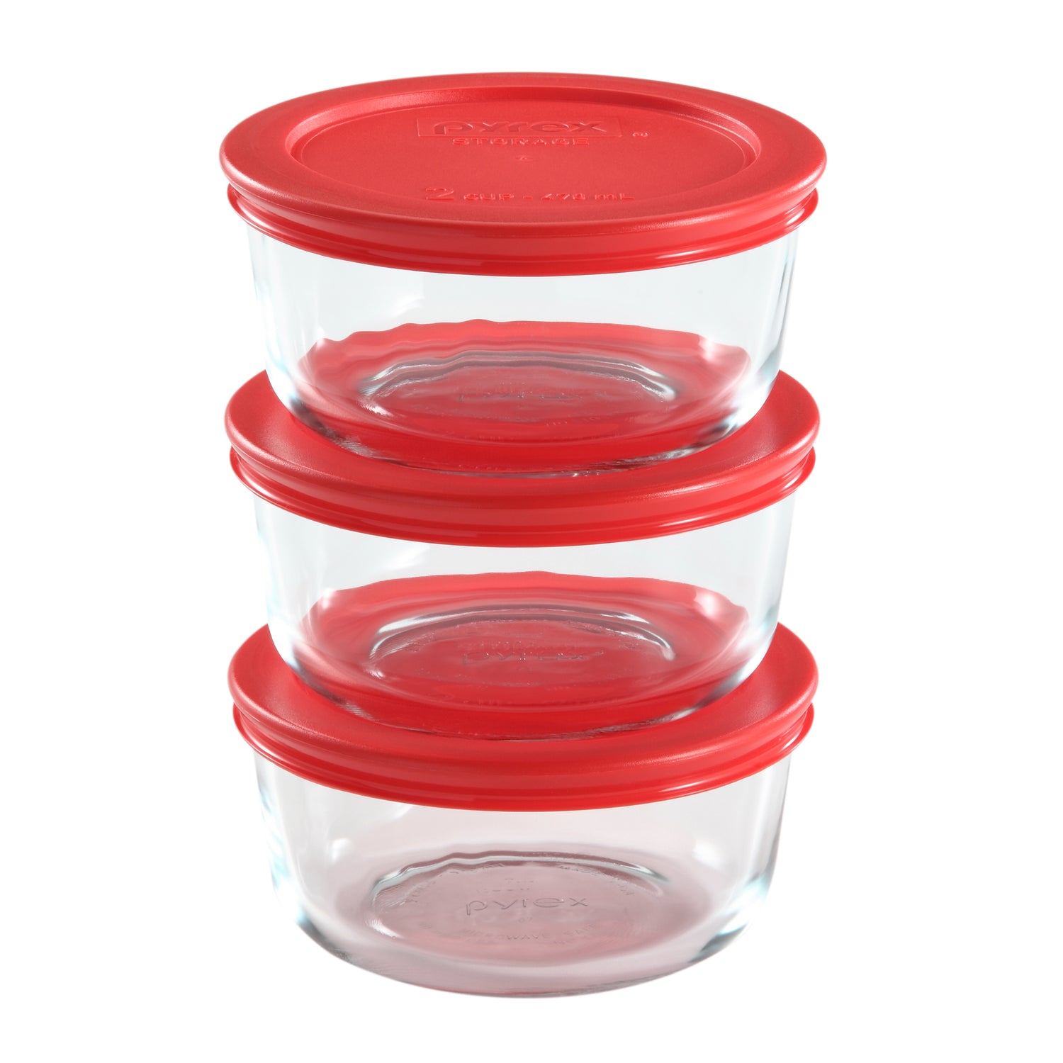 Set of glass food storage containers with red lids on a white background