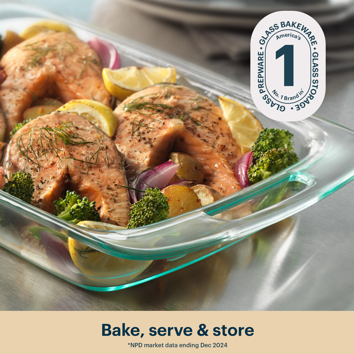 Glass baking dish with salmon and vegetables, featuring Pyrex logo.