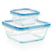 Set of glass food storage containers with blue lids on a white background