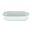 Glass baking dish with a green lid on a white background