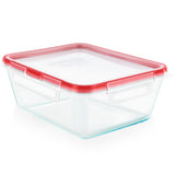Clear glass food storage container with red lid on a white background