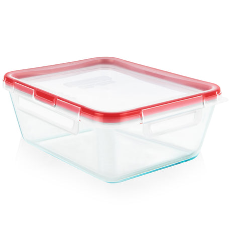 Clear glass food storage container with red lid on a white background