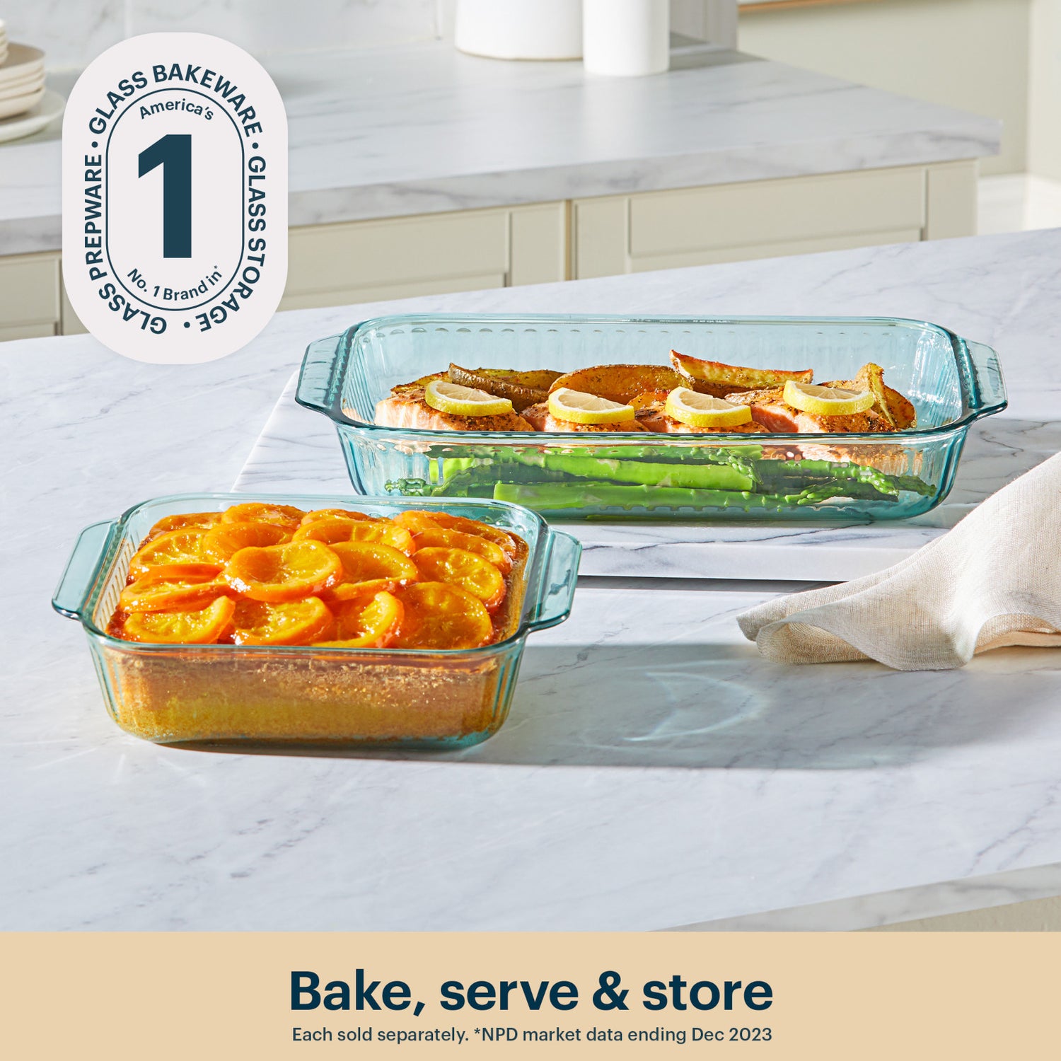 Two glass baking dishes with baked goods on a marble countertop, featuring a brand logo and text.