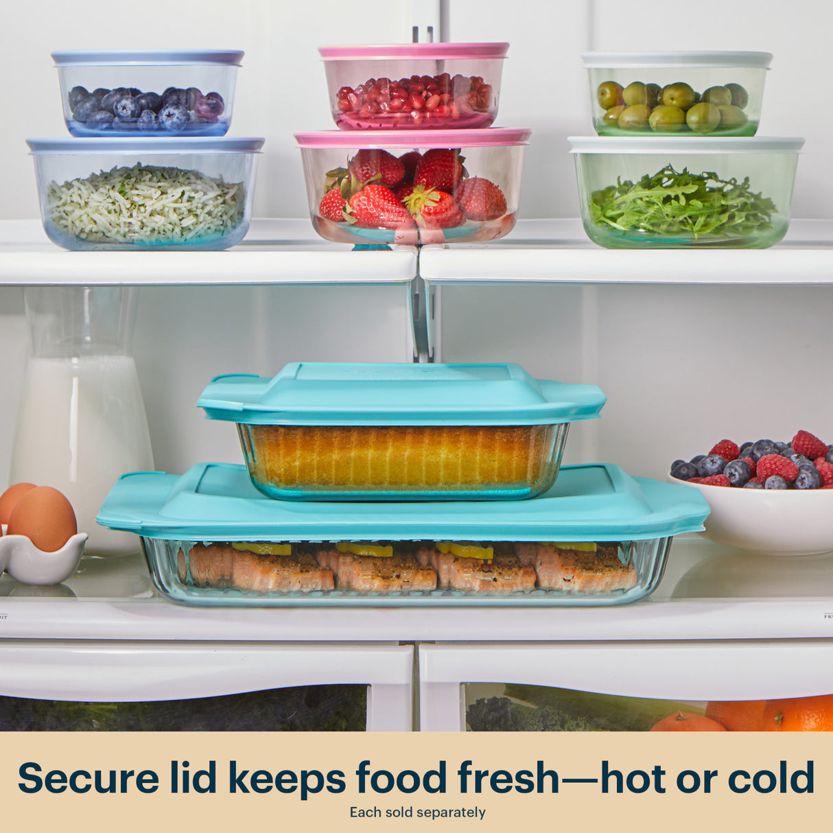 Set of glass food containers with colorful lids on a kitchen shelf.