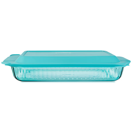 Glass baking dish with a turquoise lid on a white background