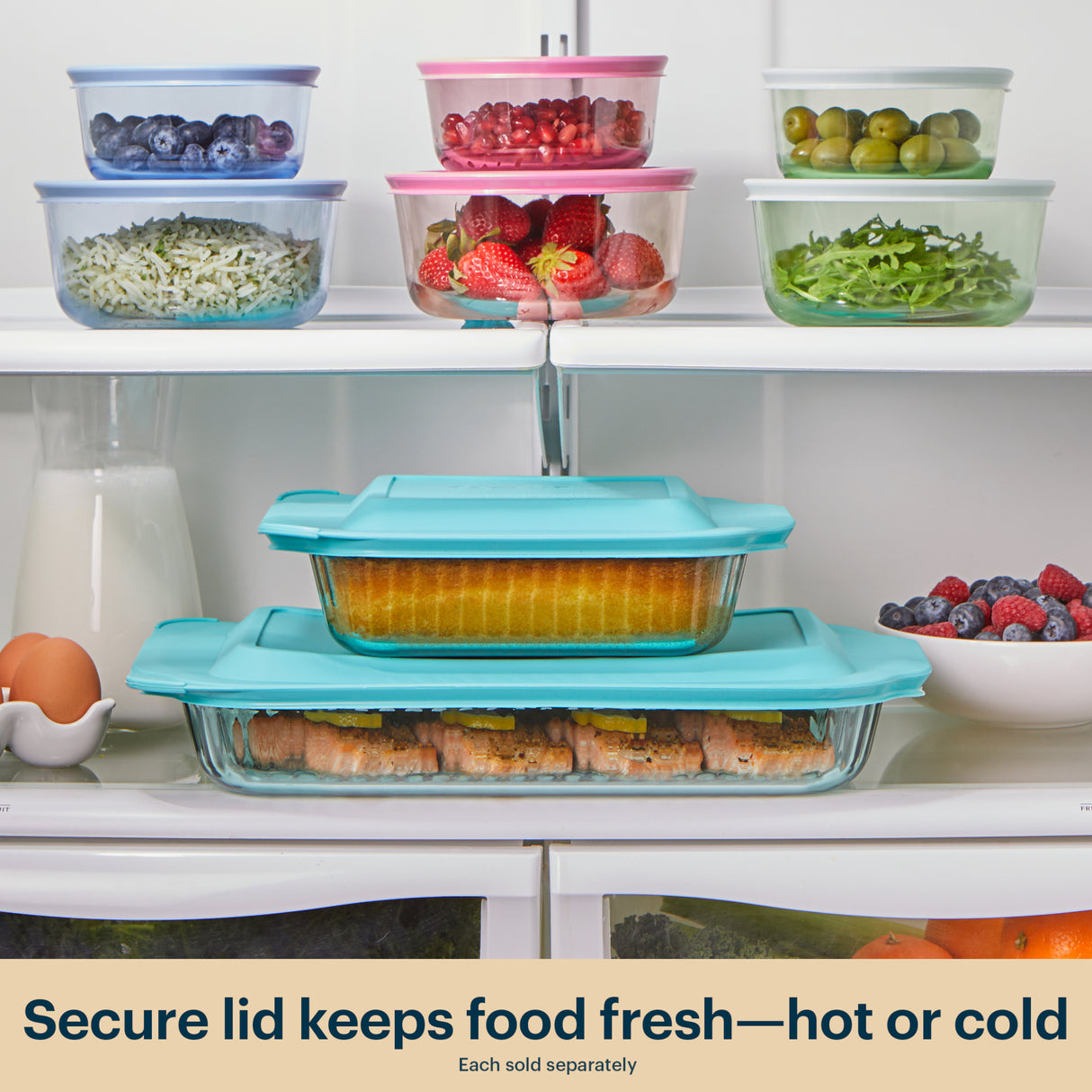 Set of glass food containers with colorful lids on a refrigerator shelf.