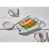 Glass food container with salad on a white tablecloth