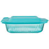 Glass baking dish with teal lid on a white background