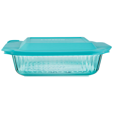 Glass baking dish with teal lid on a white background