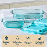 Set of glass bakeware with lids on a white surface, featuring Pyrex branding.