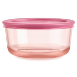 Pink food storage container with a lid on a white background