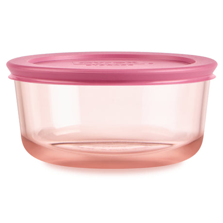 Pink food storage container with a lid on a white background