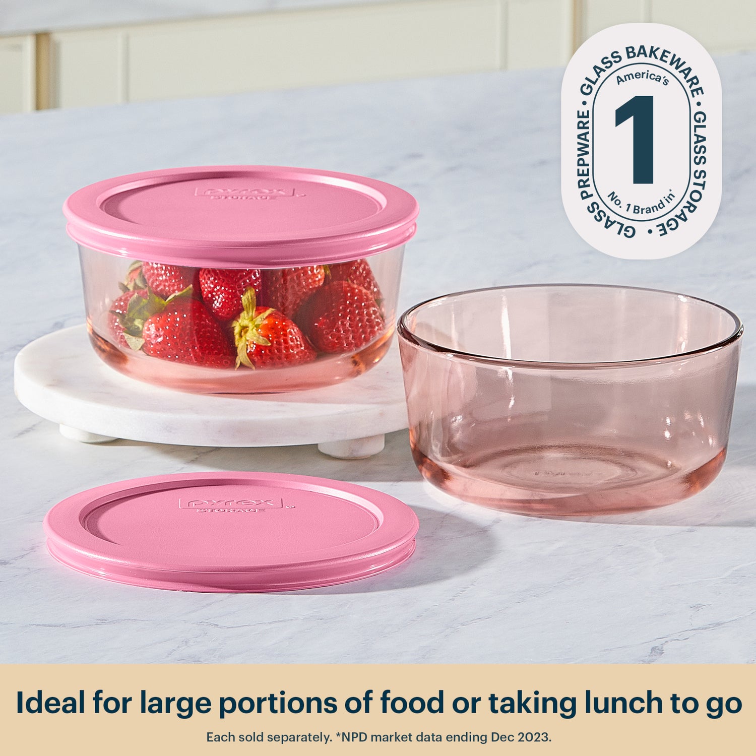 Pyrex glass food containers with pink lids on a white surface, featuring the Pyrex logo.