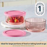 Pyrex glass food containers with pink lids on a white surface, featuring the Pyrex logo.