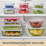 Stack of food storage containers with various foods on a refrigerator shelf.