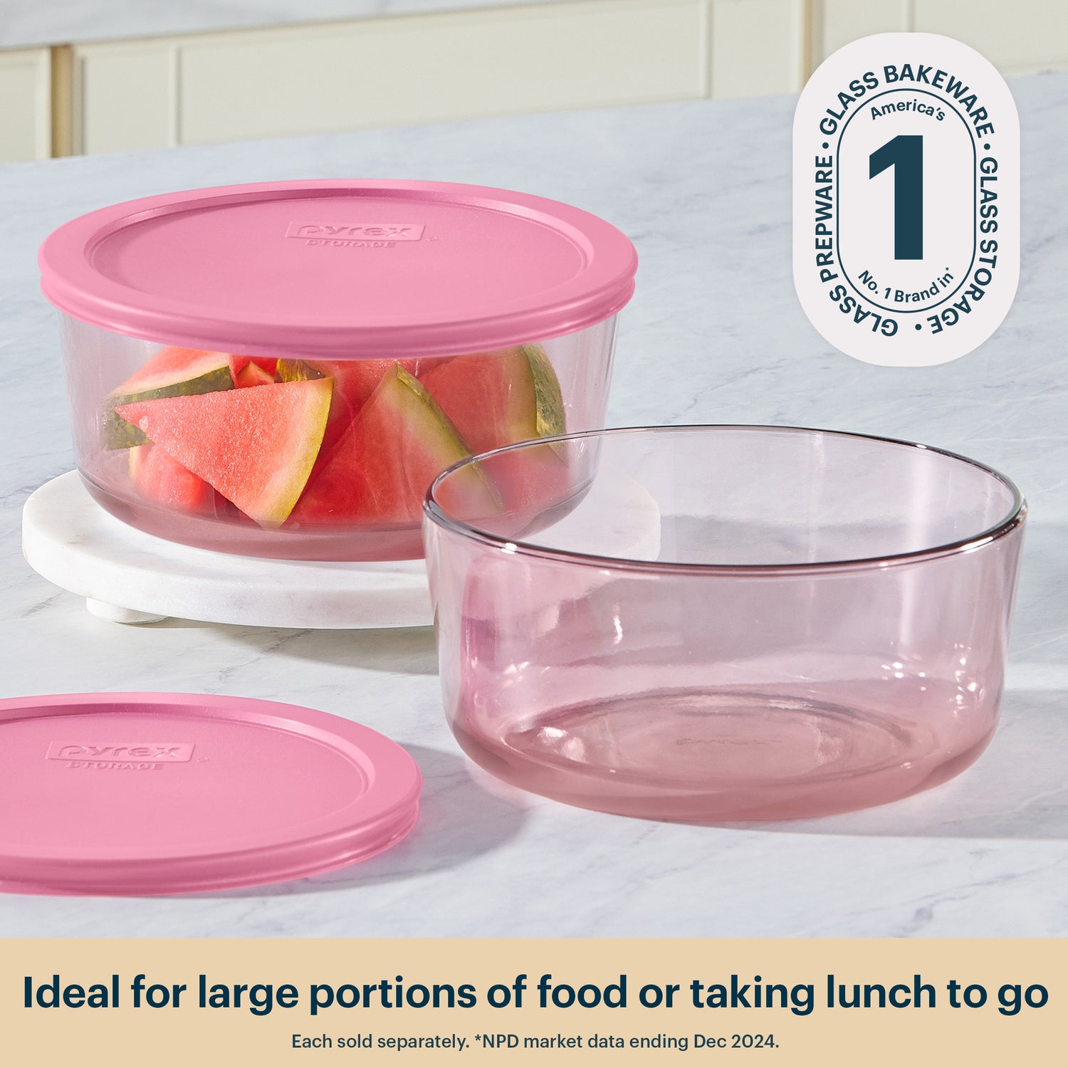 Pyrex glass food storage containers with pink lids on a white surface, featuring the Pyrex logo.
