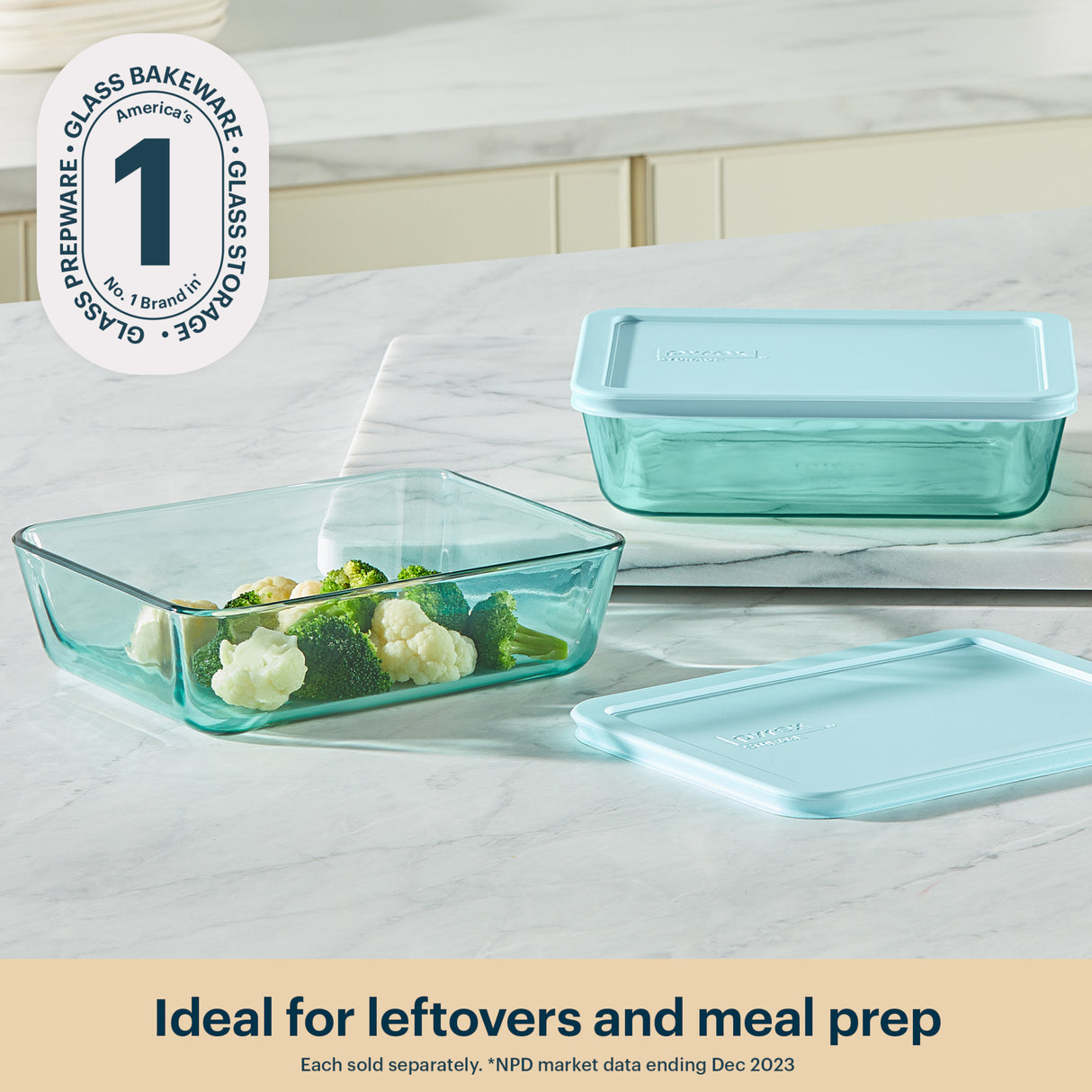 Set of glass food containers with lids on a marble surface