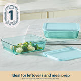 Set of glass food containers with lids on a marble surface