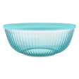 Turquoise glass bowl with ribbed design on a white background