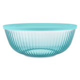 Turquoise glass bowl with ribbed design on a white background
