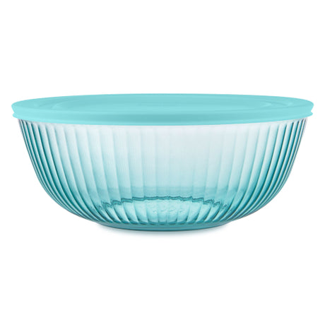 Turquoise glass bowl with ribbed design on a white background