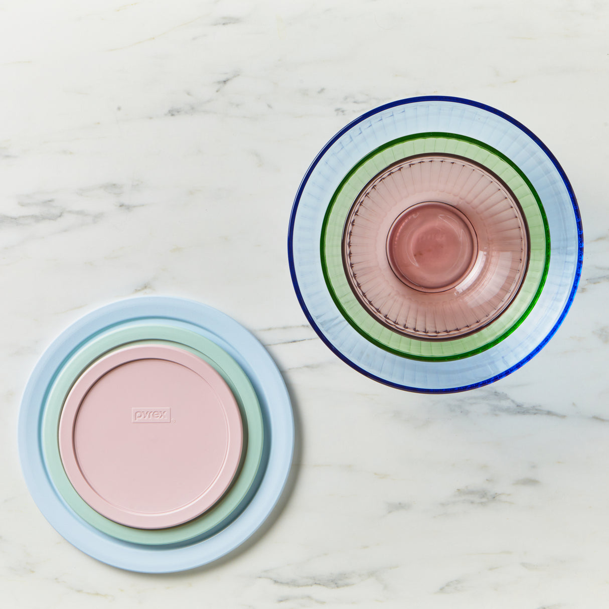 Two colorful glass plates stacked on a marble surface