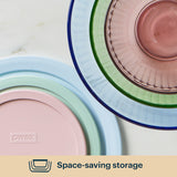 Stack of pastel-colored Pyrex dishes on a light background