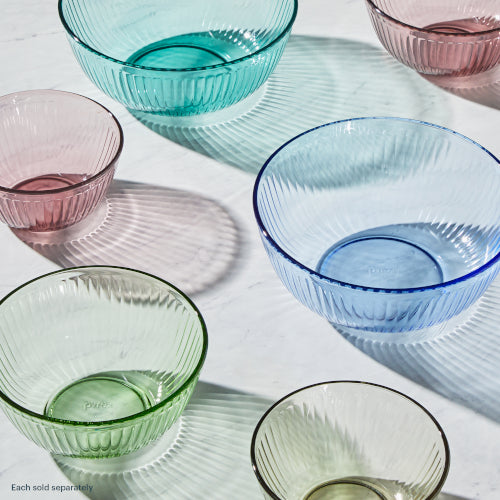 Set of colorful glass bowls on a white surface