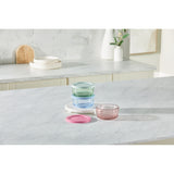 Set of colorful glass bowls on a marble countertop with a neutral background