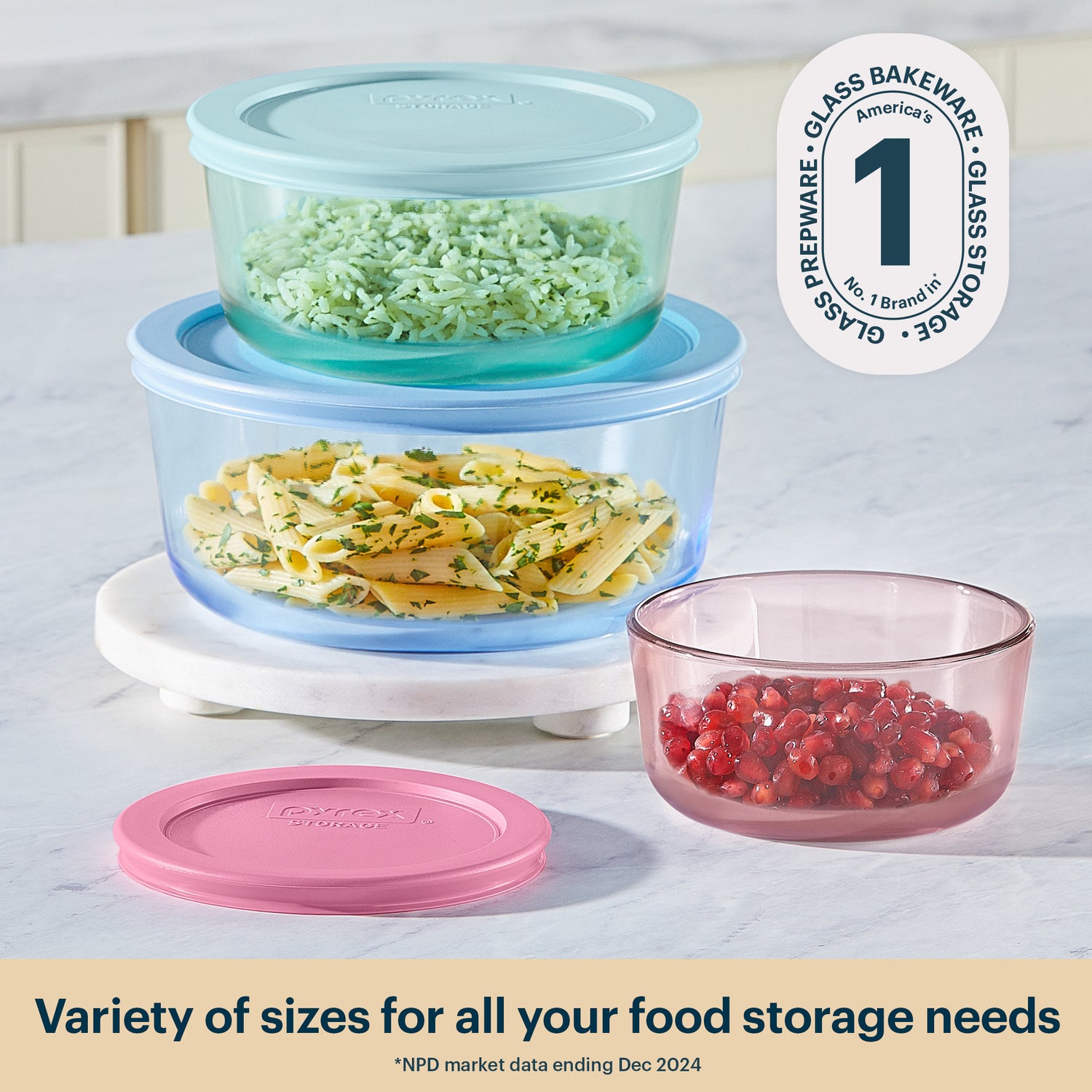 Set of glass food storage containers with lids on a countertop.