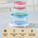 Stack of colorful glass food containers with a white background