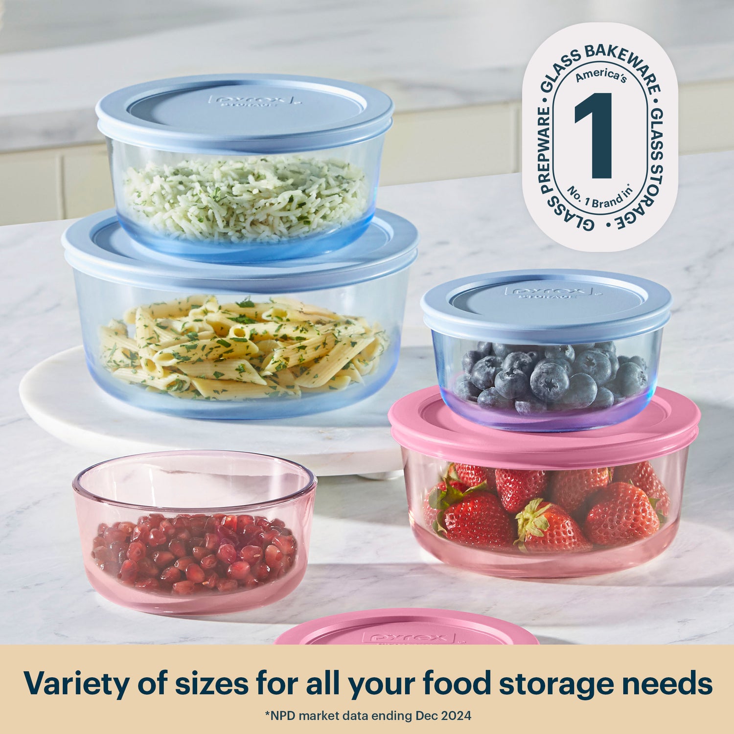 Set of glass food storage containers with lids on a kitchen counter.