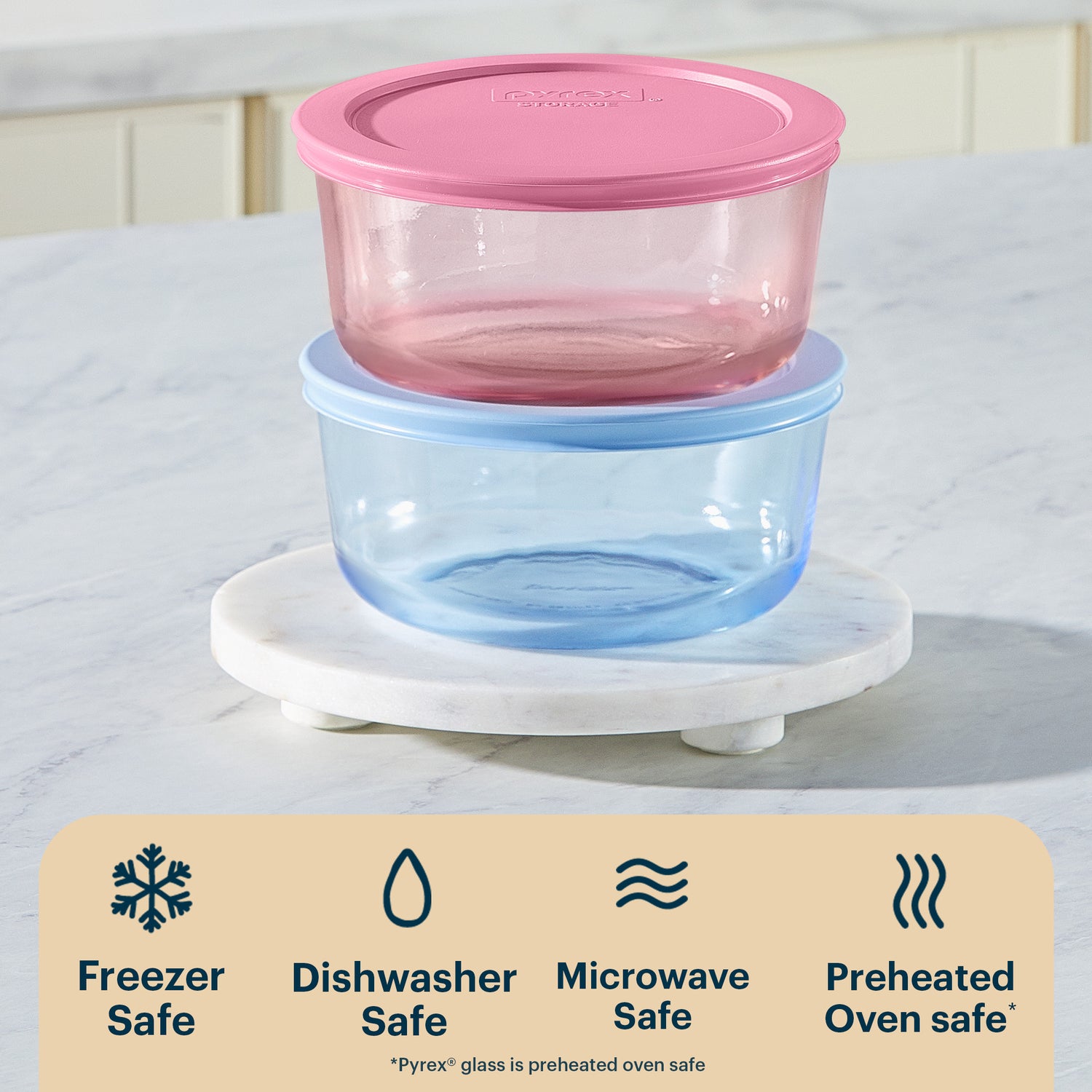 Two stacked food storage containers with pink and blue lids on a marble stand, with safety icons and text below.