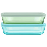 Two glass food storage containers with lids on a white background