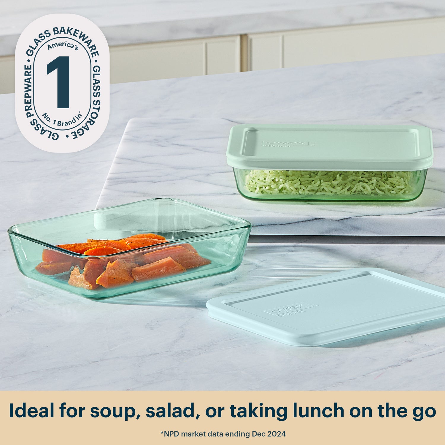 Glass food storage containers with lids on a marble surface, featuring the Glass Bakeware logo.