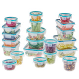 Set of clear food storage containers with blue lids filled with various foods on a white background